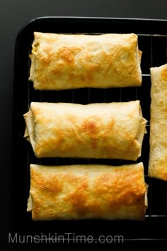 four different types of food on a black tray