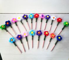 a bunch of colorful flowers sitting on top of each other next to toothbrushes