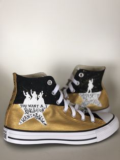 a pair of gold and black high top sneakers with the words you want a rock star on them