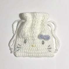 a white crocheted bag with a cat face on it's front and side