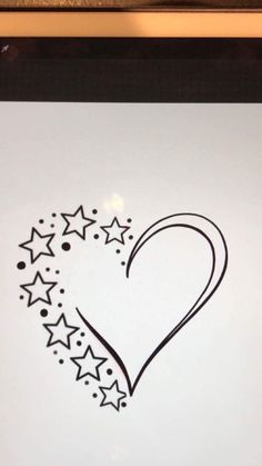 a drawing of a heart with stars in the shape of a star is shown on a white paper