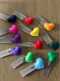 several hearts with tags attached to them sitting on a table