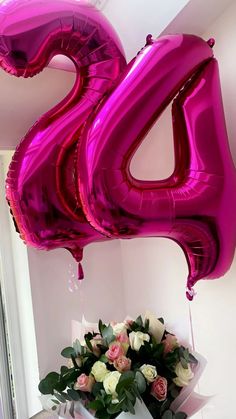 a bouquet of flowers and balloons in front of a large number balloon that says twenty