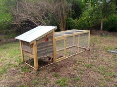 a small chicken coop in the middle of a yard