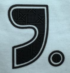 a black and white t - shirt with the letter p on it