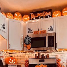 a kitchen decorated for halloween with pumpkins and decorations