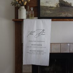 a white towel hanging from a fireplace mantel