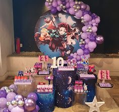 the table is set up with balloons and other items for an anime themed birthday party