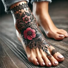 a woman's foot with flowers and leaves on the bottom part of her leg