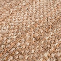 a close up view of a brown and white rug