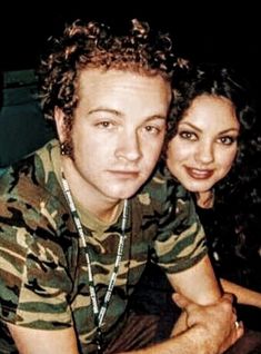 a young man and woman posing for a photo