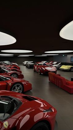 a room filled with lots of red sports cars