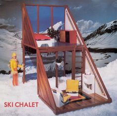 an advertisement for a doll house made out of wood and glass in the middle of snow