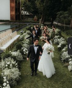 the bride and groom are walking down the aisle