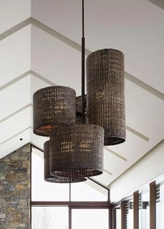 a large chandelier hanging from the ceiling in a room with stone walls and windows