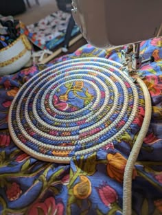 a close up of a sewing machine on a table with some fabric and other items