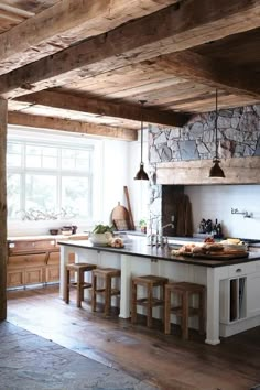 a kitchen with an island and wooden beams