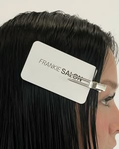 a close up of a person with a hair clip on their head and the words franie safoon written on it