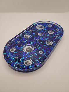 a blue and black cell phone case sitting on top of a white surface with buttons