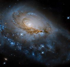 an image of a spiral galaxy with stars in the foreground and blue light at the top