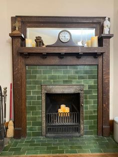 a fireplace with candles and a clock on top