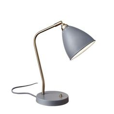 a desk lamp that is on top of a white surface with a cord attached to it