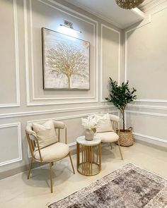 a living room with two chairs and a rug on the floor in front of it