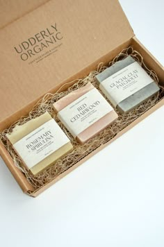 three soaps in a box on a table