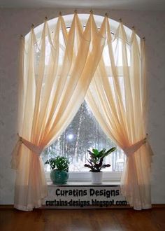 an image of a window with curtains on the windowsills and potted plants