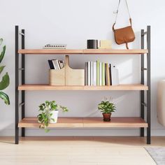 a wooden shelf with books and plants on it