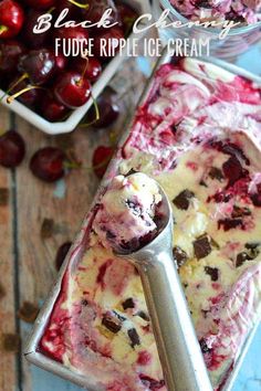 an ice cream sundae with cherries in the background