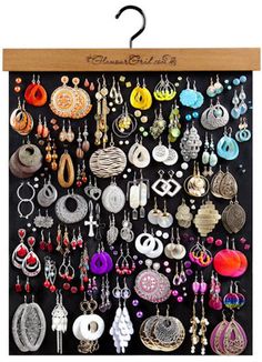 a black board with lots of earrings hanging on it