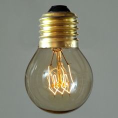 a light bulb that is turned on and has some wires attached to the inside of it