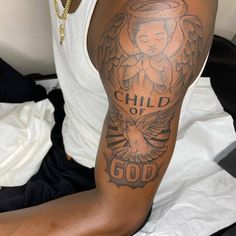 a man with a tattoo on his arm that says child of god and an angel