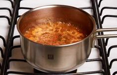 a pot filled with food sitting on top of a stove