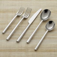 four silverware on a marble surface with spoons and forks