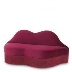 a large pink couch sitting on top of a white floor