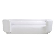 a white couch sitting on top of a white floor