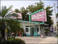 a pink and green building with a sign that says the shalim's motel