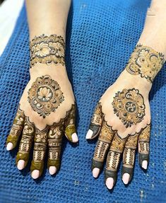 two hands with henna designs on them