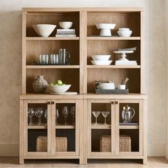 a wooden shelf filled with dishes and glasses