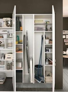 an open closet filled with lots of different types of items in it's shelves