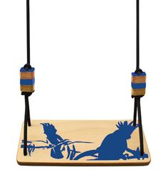 a wooden swing with blue and white silhouettes on the front, hanging from two black cords