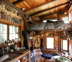 the interior of a tiny cabin with lots of windows