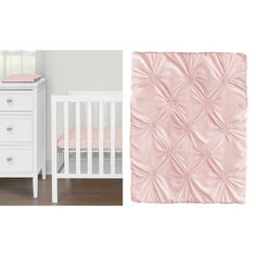 a baby crib with a pink blanket next to a white dresser and bedding