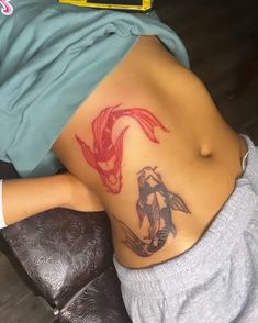 a woman with a fish tattoo on her stomach