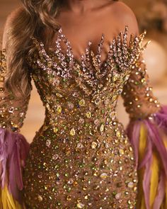 a woman with long hair wearing a gold and purple dress