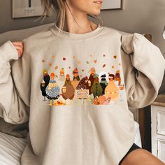 Fall Chicken Sweatshirt, Halloween Chicken Sweatshirt, Women Chicken Sweatshirt, Pumpkin Chickens, Animal Sweatshirt,Fall Farmer Farm Shirt Thank you so much for taking the time to browse my shop. Please feel free to reach out if you have any questions before or after purchasing.  💖 🎨Warning: On products with a print chart in the listing, metallic print colors are printed as matte. We design and cut each graphic out with a soft touch, use matte vinyl and a heat press. The result will last for Fall Long Sleeve Tops With Funny Print, Relaxed Fit Cartoon Print Top For Fall, Cute Fall T-shirt, Funny Print Long Sleeve Sweatshirt For Fall, Long Sleeve Sweatshirt With Funny Print For Fall, Chickens Animal, Fall Sweatshirt With Funny Print And Relaxed Fit, Cute Fall Sweatshirt With Funny Print, Funny Print Long Sleeve T-shirt For Fall