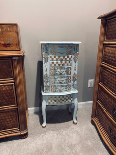 three wooden dressers with different designs on them in a room next to each other