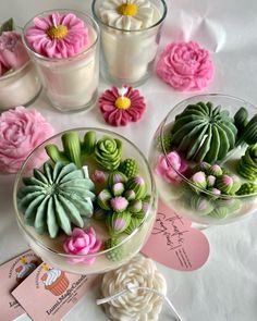 small glass vases filled with flowers on top of a table